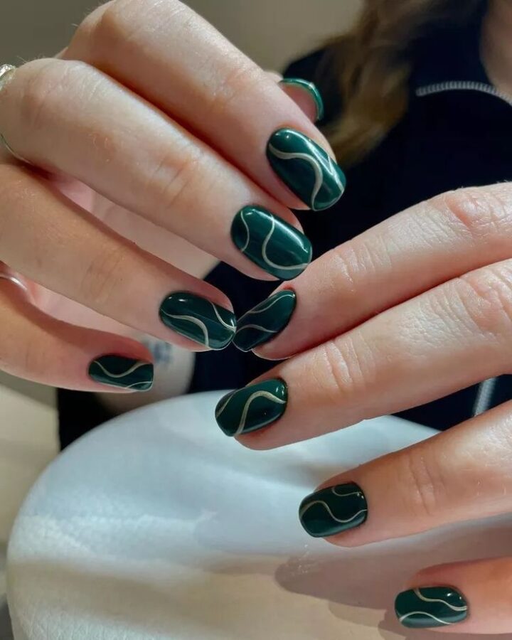 Express your individuality with these bold and funky green nails. The unique design is sure to turn heads. #deepgreennails #expressyourself #nailart