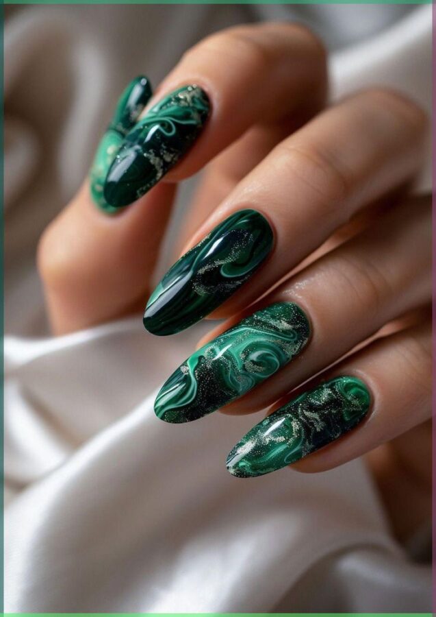 This image showcases a stunning manicure featuring a dark green malachite marble pattern. The intricate swirls and veins create a luxurious and eye-catching effect. #darkgreenmanicure #malachite #nailart