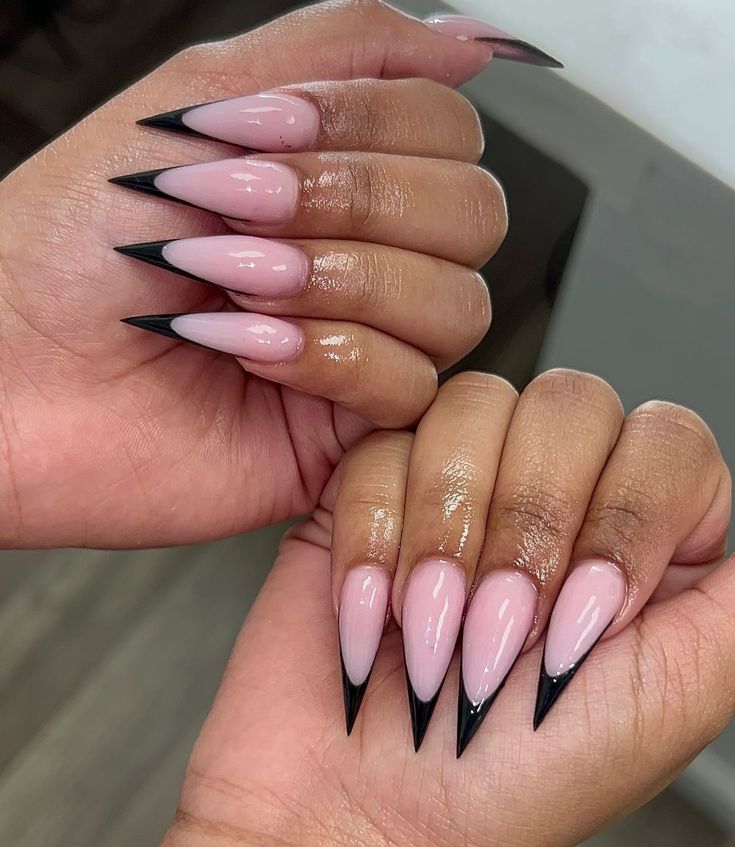 Sleek and sophisticated: These black French stiletto tips make a bold statement. A modern and edgy twist on a classic manicure. #BlackFrenchTips #StilettoNails #EdgyNails #ModernManicure #NailArt #ChicNails #DarkNails