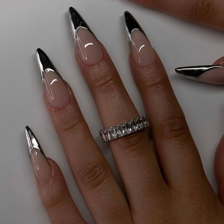 These chrome French stiletto nails reflect light with a dazzling, mirror-like finish. A modern and eye-catching take on a classic design. #ChromeNails #FrenchStilettoNails #StilettoNails #MirrorNails #FuturisticNails #GlamNails #NailArt