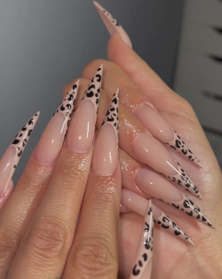 Wild and chic: These leopard print French stiletto tips combine the elegance of a French manicure with the bold statement of animal print.  A trendy and glamorous nail design. #LeopardPrintNails #FrenchStilettoNails #StilettoNails #AnimalPrintNails #NailArt #TrendyNails #GlamNails