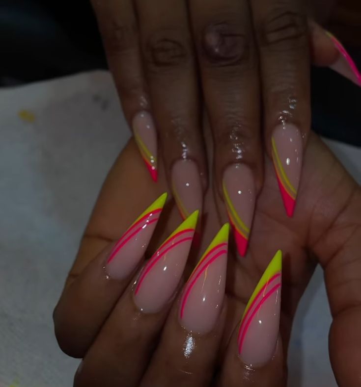 Make a statement with these vibrant neon French tip stiletto nails.  A bold and playful take on a classic design. #NeonNails #FrenchTips #StilettoNails #BrightNails #NailArt #SummerNails #TrendyNails