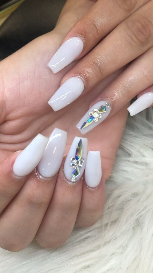 Elegant white embellished nails offering a sophisticated and glamorous option for baddie nail ideas.