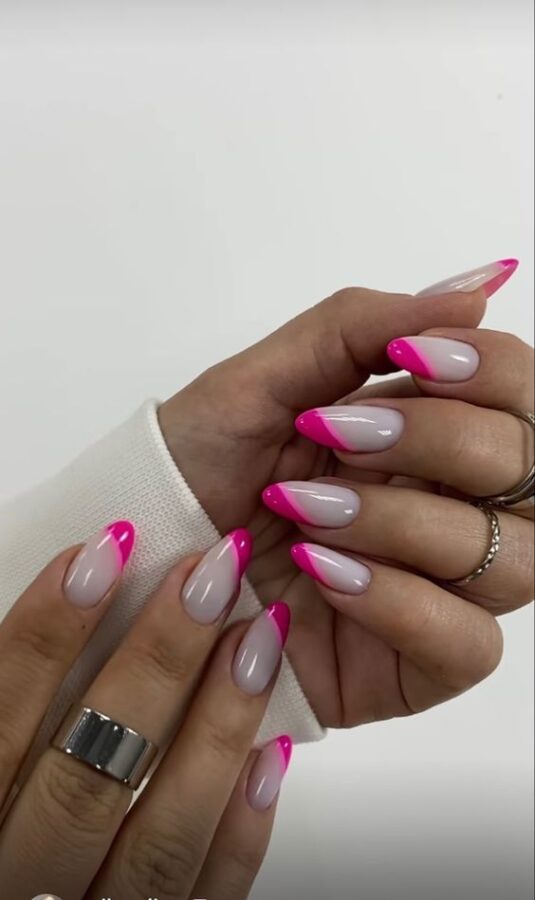 A modern twist on a classic! These asymmetric French tip pink nails feature varying lengths and angles on the tips, creating a unique and stylish manicure. #AsymmetricNails #FrenchTips #PinkNails #NailArt #ModernManicure