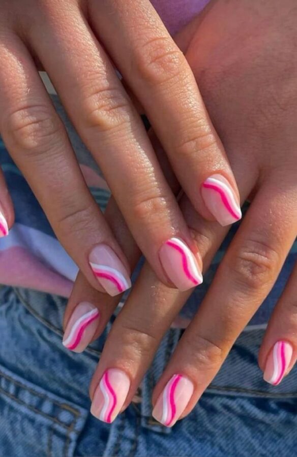 A playful twist on a classic! These cute French nail tips feature hot pink swirls, adding a touch of fun and color to a timeless manicure. #FrenchTips #HotPinkSwirls #NailArt #CuteNails #SwirlNails