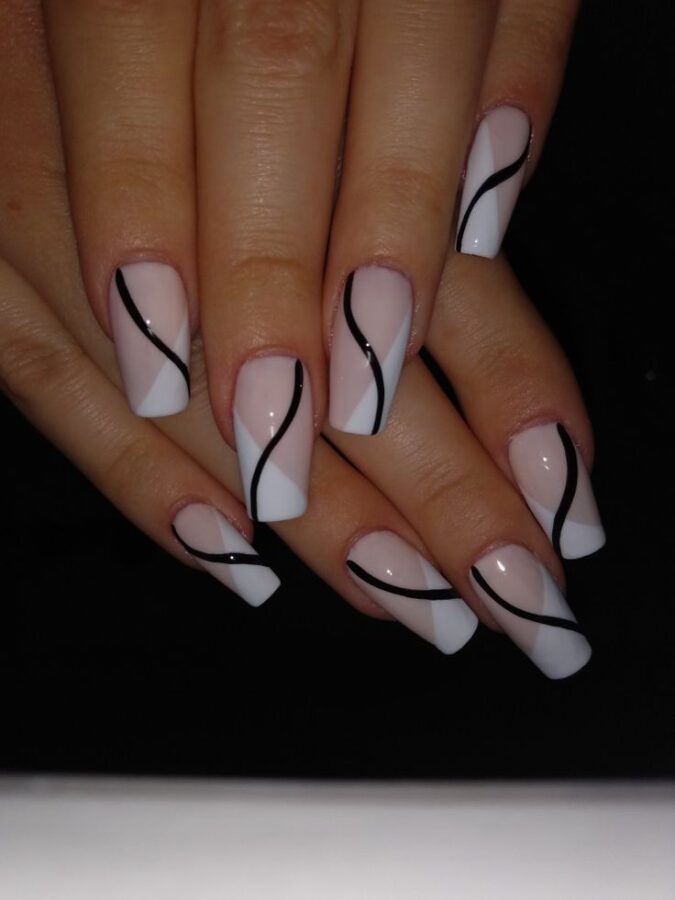 A hand showcases nails with thin line designs, a clean and modern minimalist nail art style. #LineNails #MinimalistNails #NailArt #ModernDesign