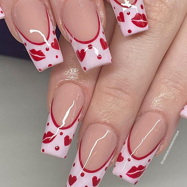 Playful Valentine's Day nails featuring a mix of red polka dots and delicate hearts.