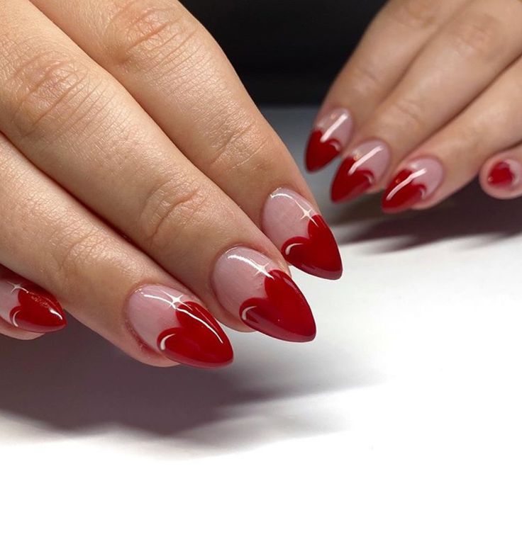 Easy and chic Valentine's Day nail art featuring simple red hearts on a nude base."