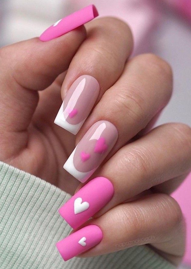 A chic and classic French manicure with a touch of love, these heart-shaped tips are ideal for Valentine's Day. #FrenchNails #HeartDesign #ValentinesDayMani #FebruaryNailArt