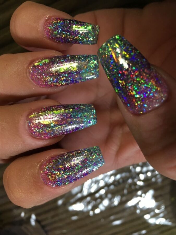 These nails are adorned with colorful confetti, glitter, and festive designs inspired by Mardi Gras.  #ConfettiNails