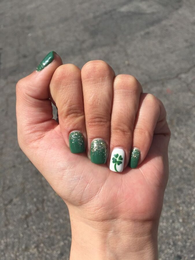 Green and gold four-leaf clover nails perfect for celebrating St. Patrick's Day. #GreenAndGoldNails #FourLeafCloverNails #StPatricksDayNails #FestiveManicure #IrishInspiredNails