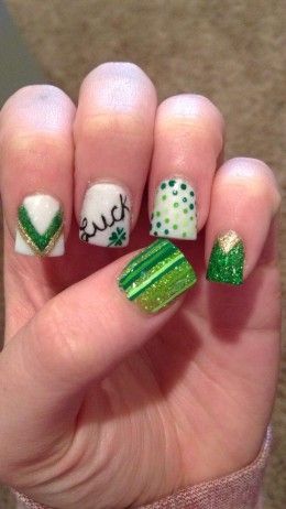 Celebrate St. Patrick's Day with these festive green stripes and dots nails. #StPatricksDay #NailArtInspiration #HolidayNails #FestiveNails #CelebrationNails