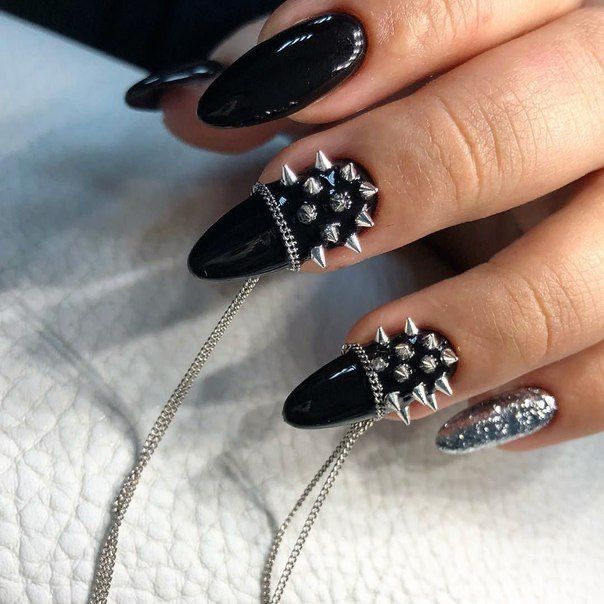 This image showcases nails painted with a leather-like texture and accented with studs, a cool and edgy Western nail art idea. #westernnaildesignideas #leatherandstuds #manicure