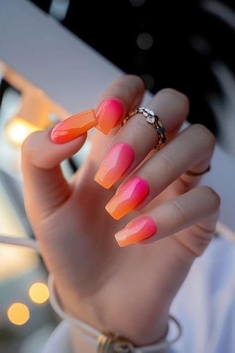 Capture the vibrant hues of a spring sunset with these stunning ombré nail designs. #OmbreSunsetNails #SunsetNails 