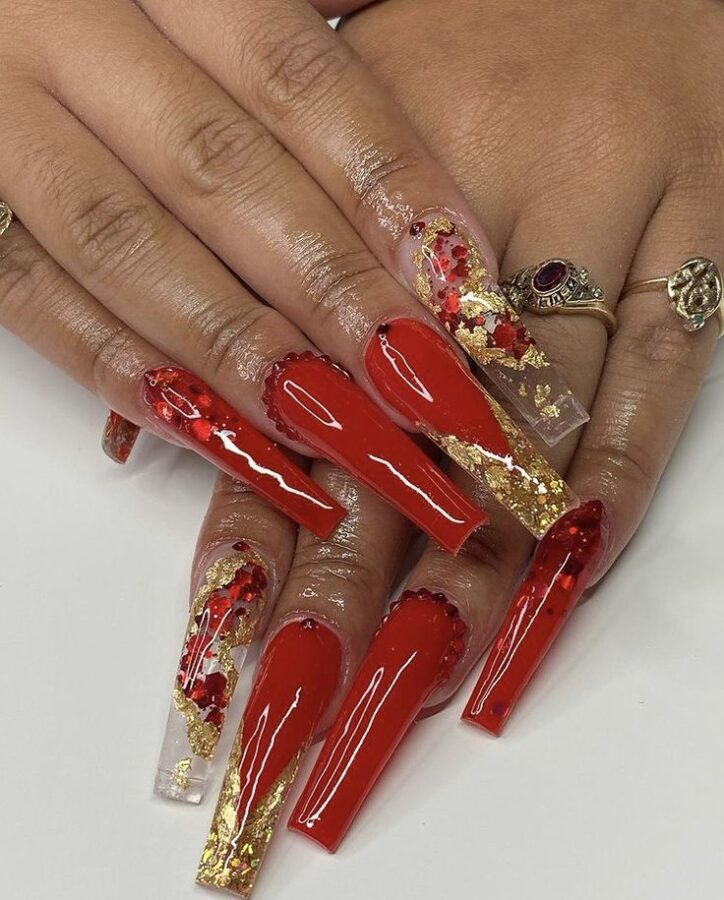 Get rodeo-ready with these festive red and gold nail designs. #westernnaildesigns #rodeoready #nailart