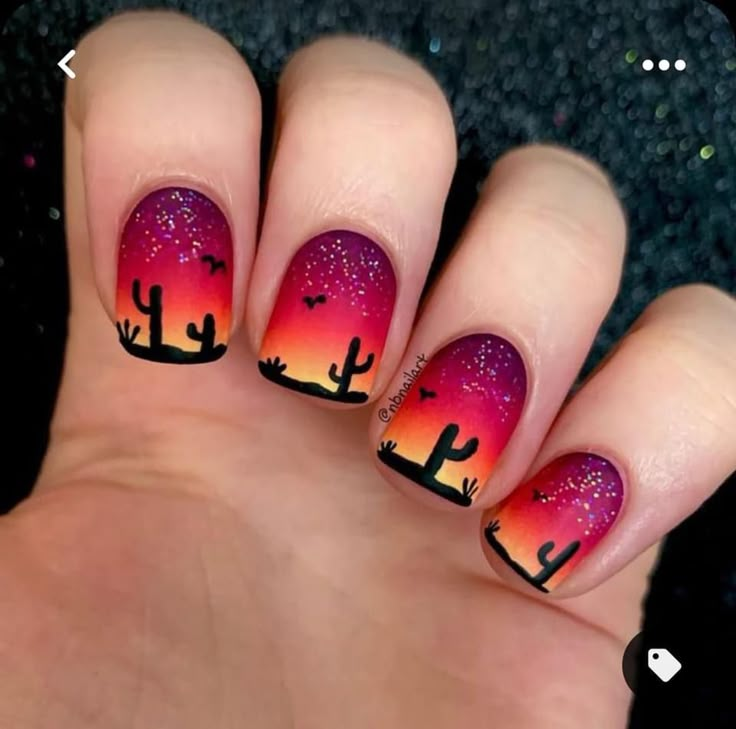 Capture the beauty of the desert sunset on your nails with this Western-inspired design. #westernnailart #desertsandscape #sunsetmanicure